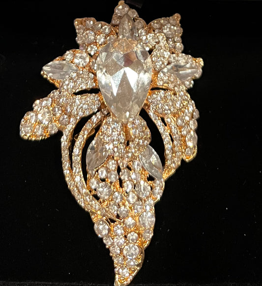 Gold tone floral pave bouquet brooch with rhinestones.