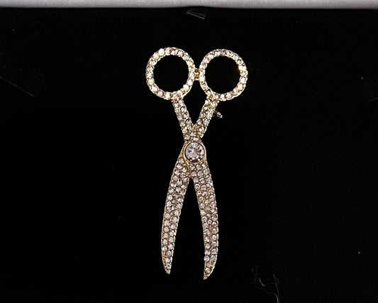 Gold tone and rhinestone pave scissor brooch pin.