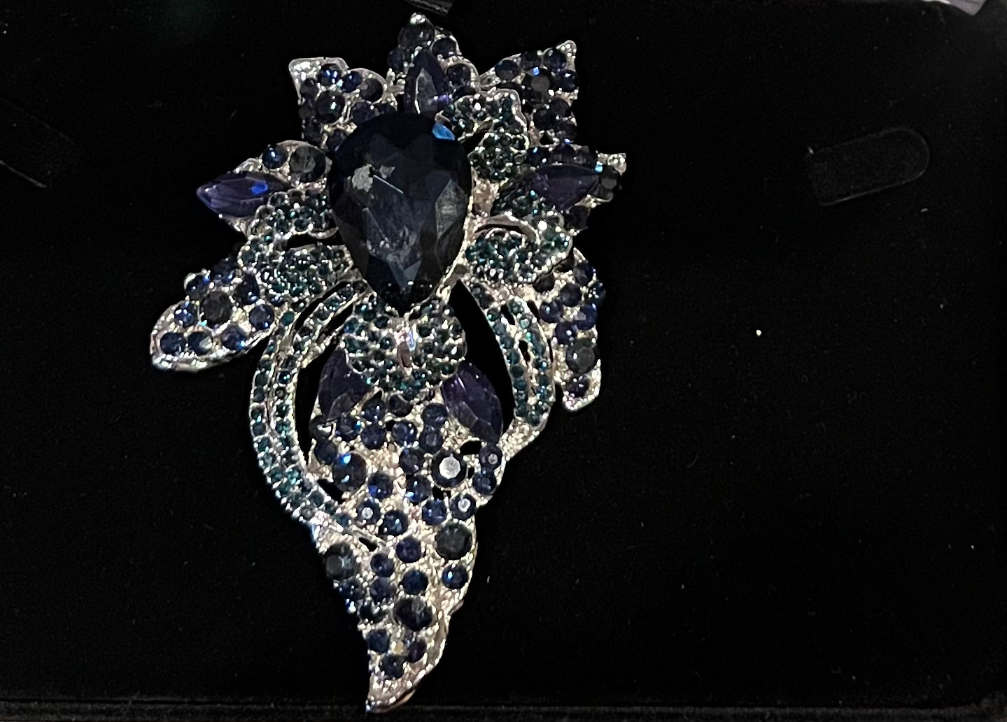 Navy blue floral crystal pave bouquet brooch.