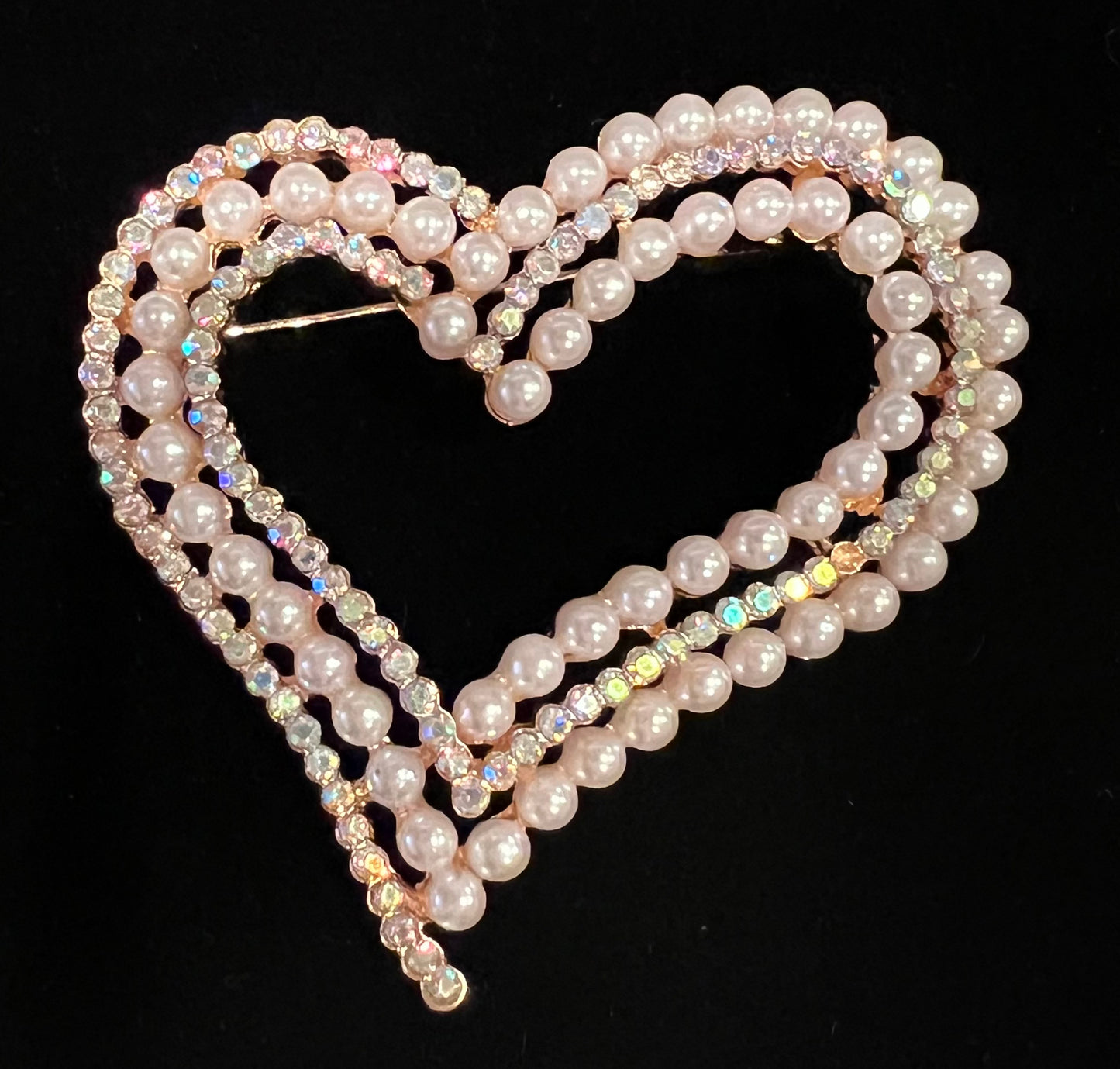 Gold tone heart brooch with pearls and tricolor rhinestones.