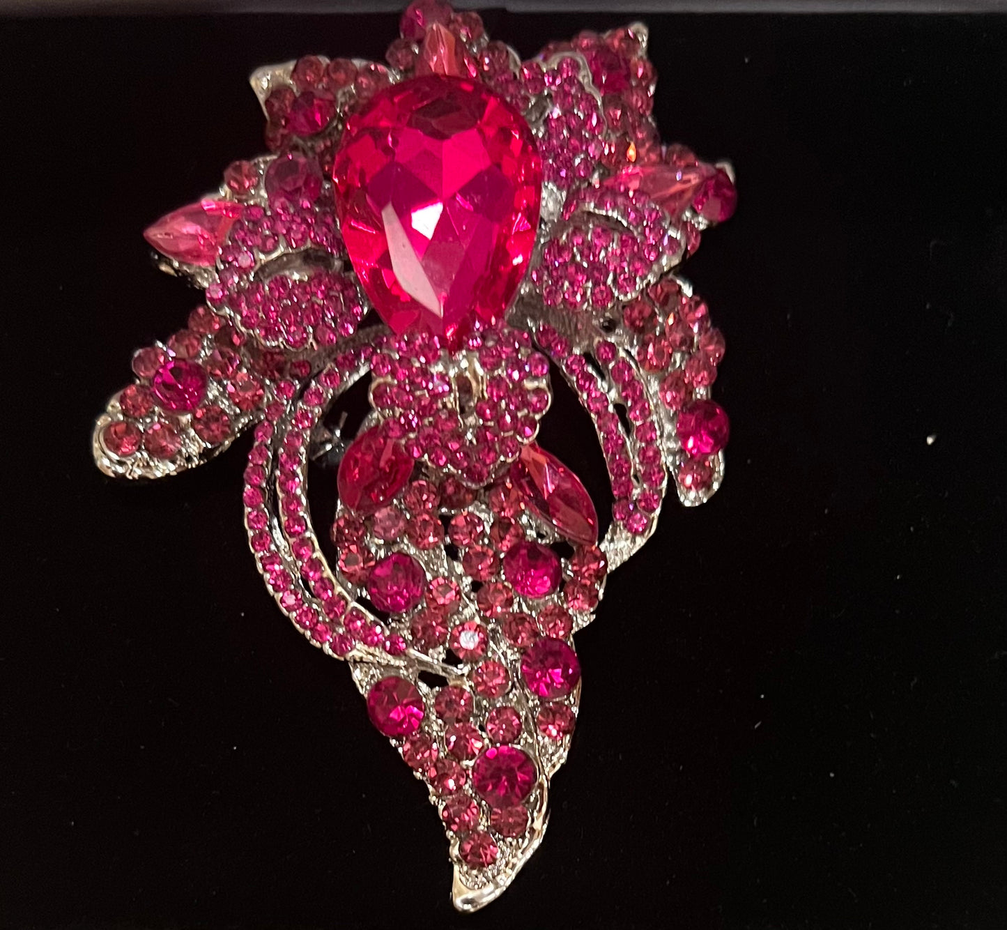 Fuchsia floral crystal pave bouquet brooch.