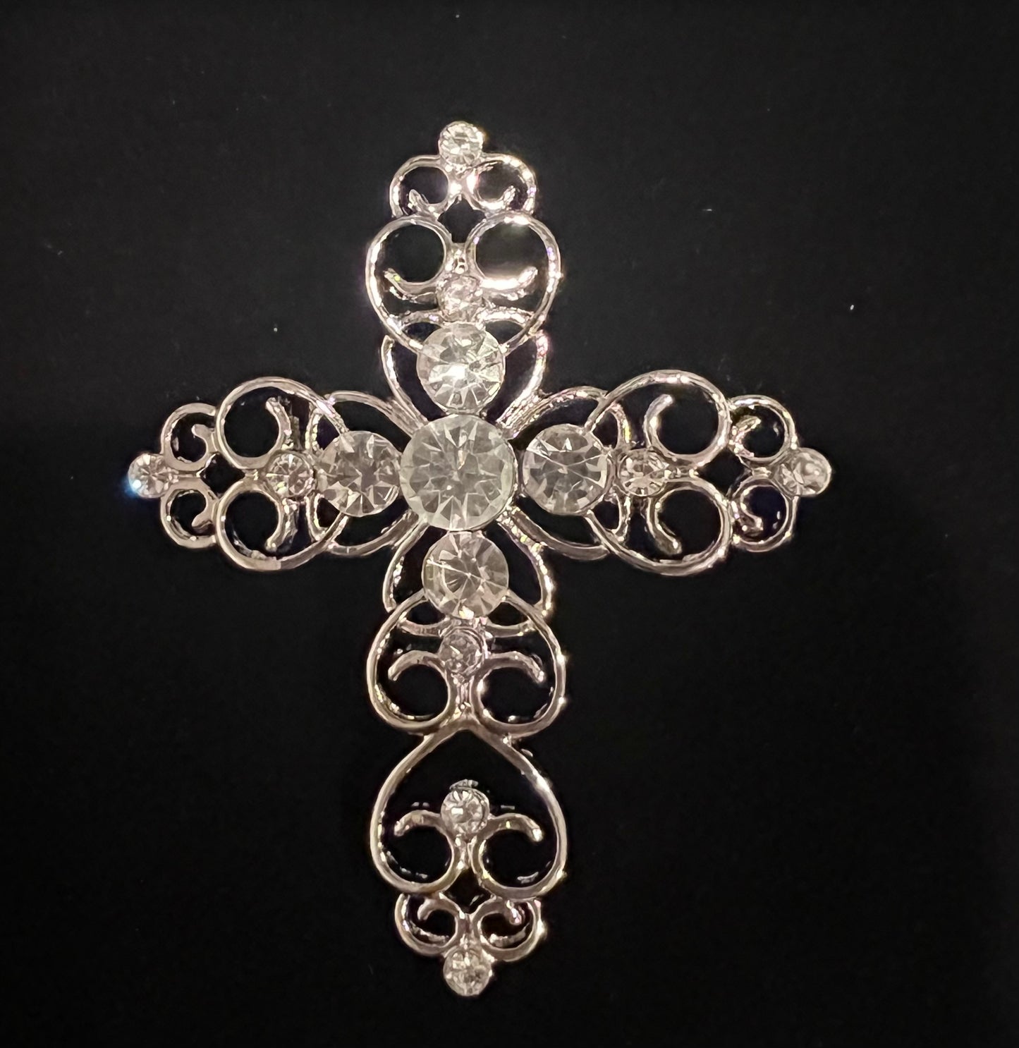 Silver tone cross with rhinestones.