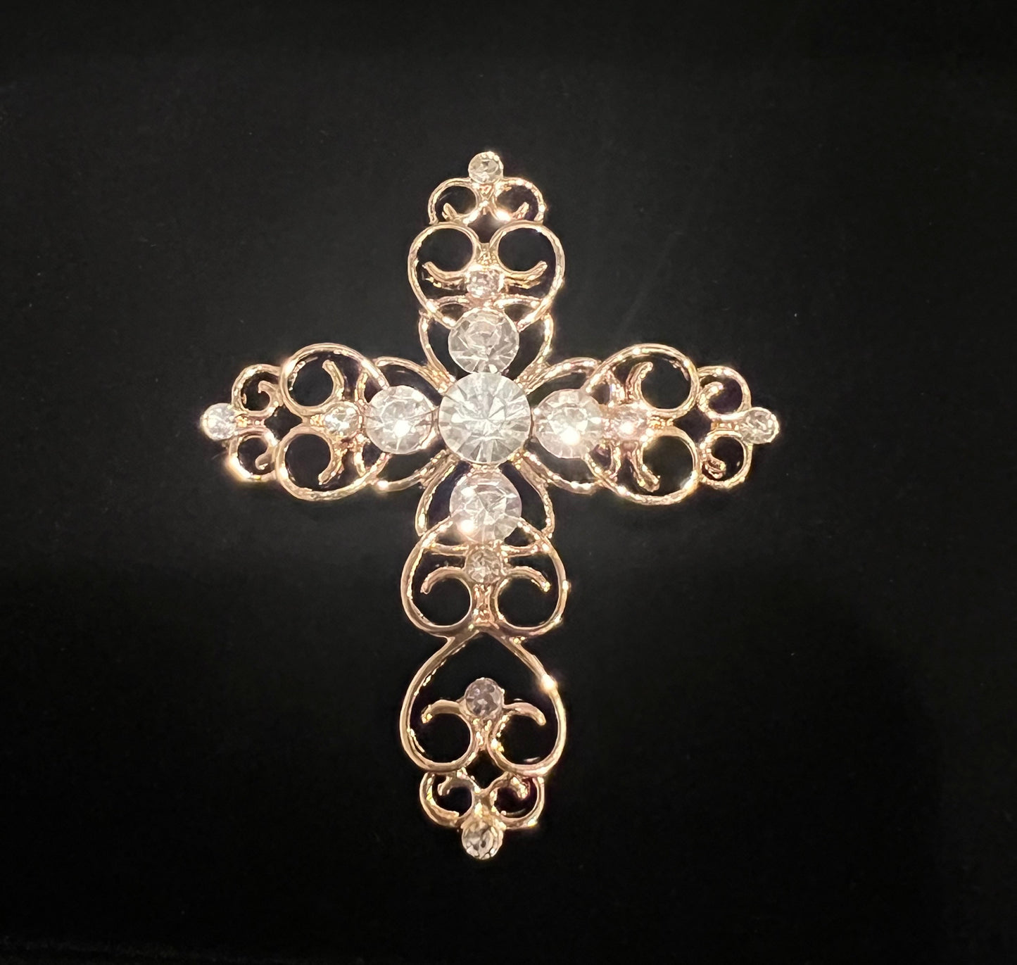 Goldtone cross with rhinestones.