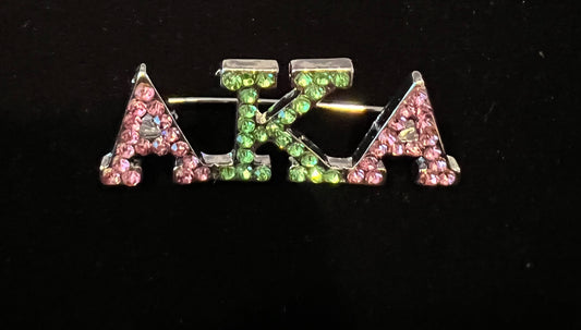 Alpha Kappa Alpha brooch w/pink and green rhinestones.